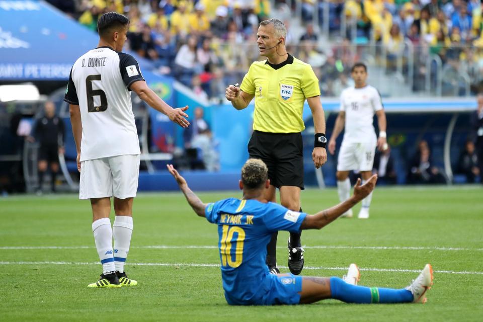  Neymar sits on the floor as Bjorn Kuipers gives a later-rescinded penalty.