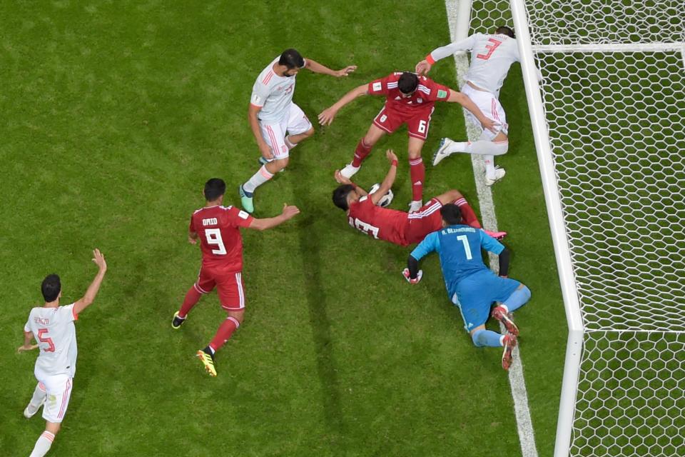  Bedlam ensues in the Iranian penalty area, with Diego Costa looking to pounce