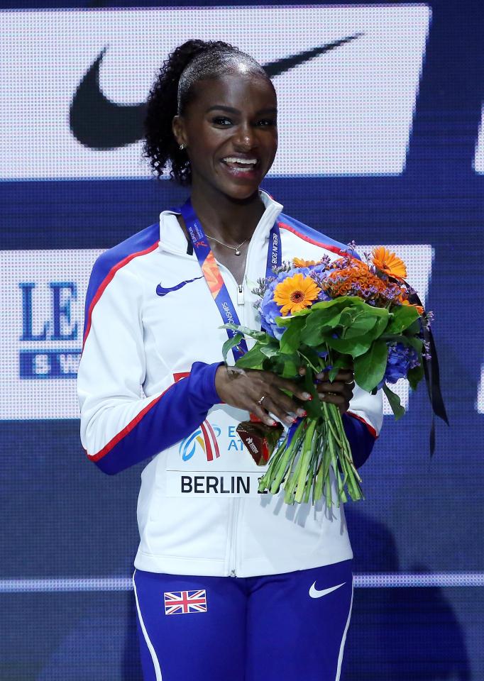  Dina Asher-Smith posing with her 100m gold medal