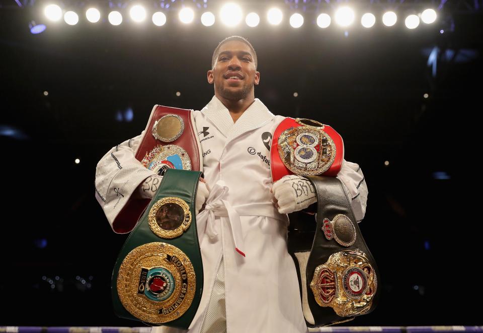  Joshua shows off his belts after beating Joseph Parker
