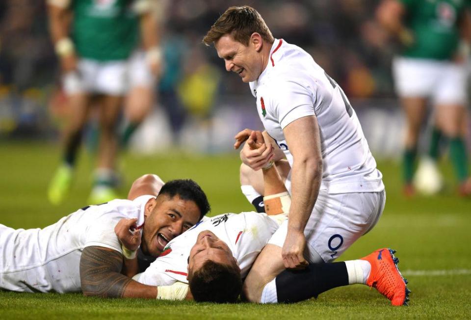  Manu Tuilagi and Chris Ashton celebrate with two-try hero Slade in Dublin