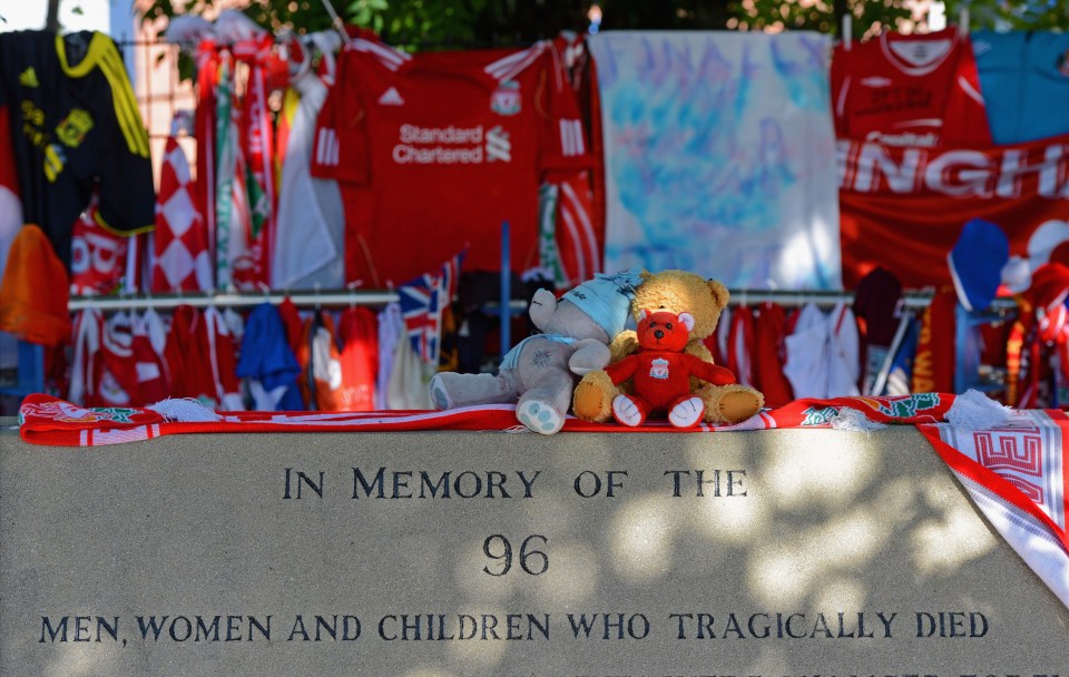  Tributes are placed around a vigil outside Anfield