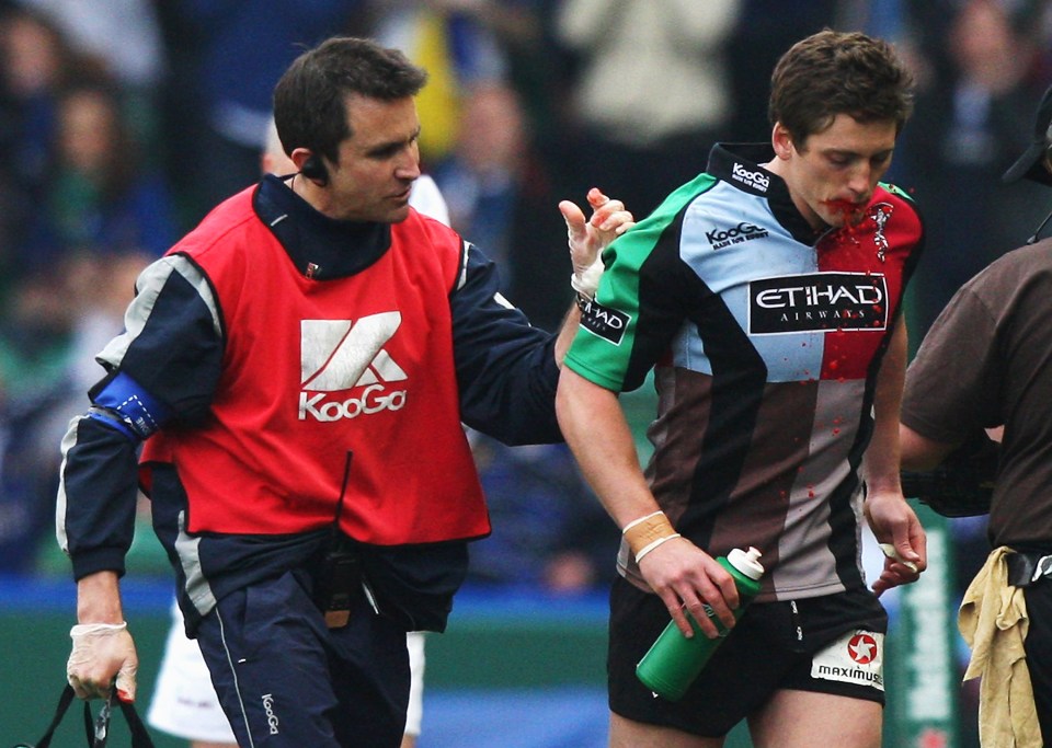  Williams is helped from the pitch by Steph Brennan with 'blood' pouring from his mouth