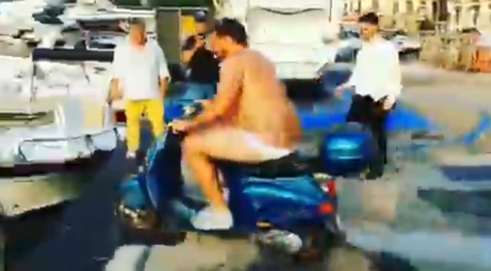  Balotelli watched on with a crowd as the man, wearing nothing but his pants, drove into the sea