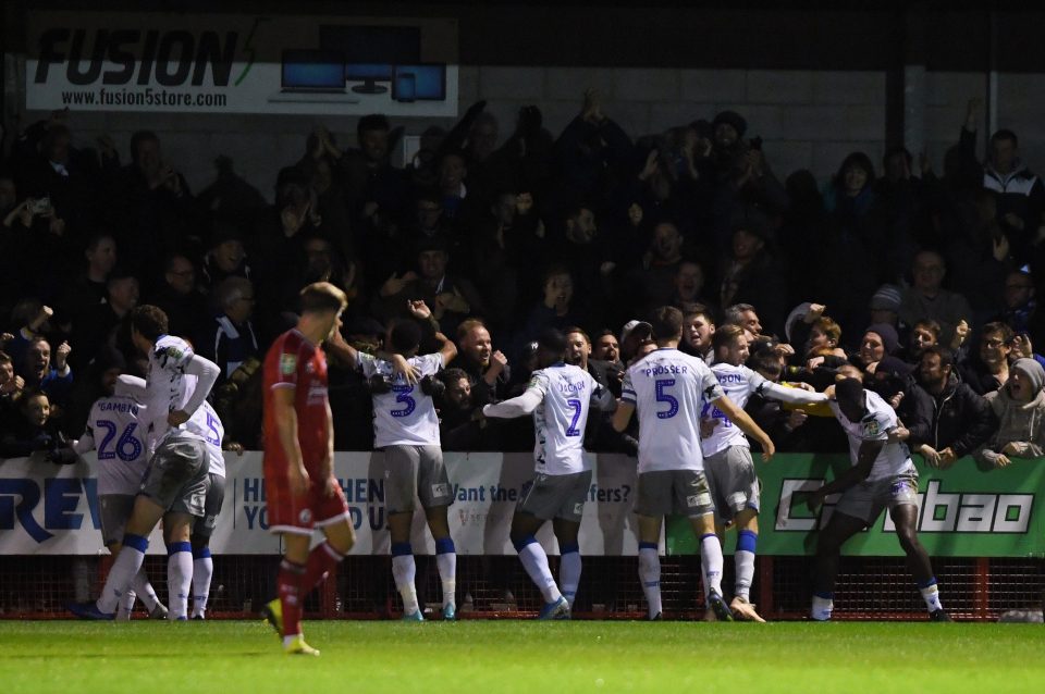  Colchester players celebrate with fans after they edged past Crawley