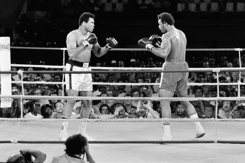 Muhammad Ali and George Foreman boxing in the ring.