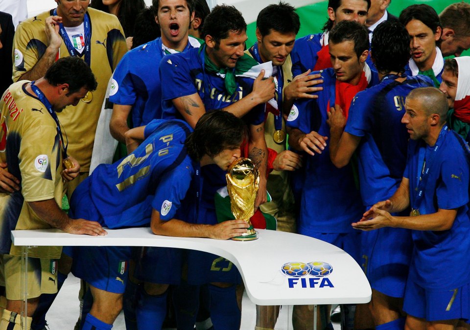 Andrea Pirlo kisses the World Cup he won in 2006