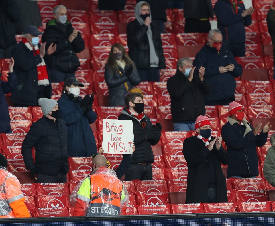  An Arsenal fan help up a ‘Bring Back Ozil’ sign during the club’s Europa League clash with Rapid Vienna