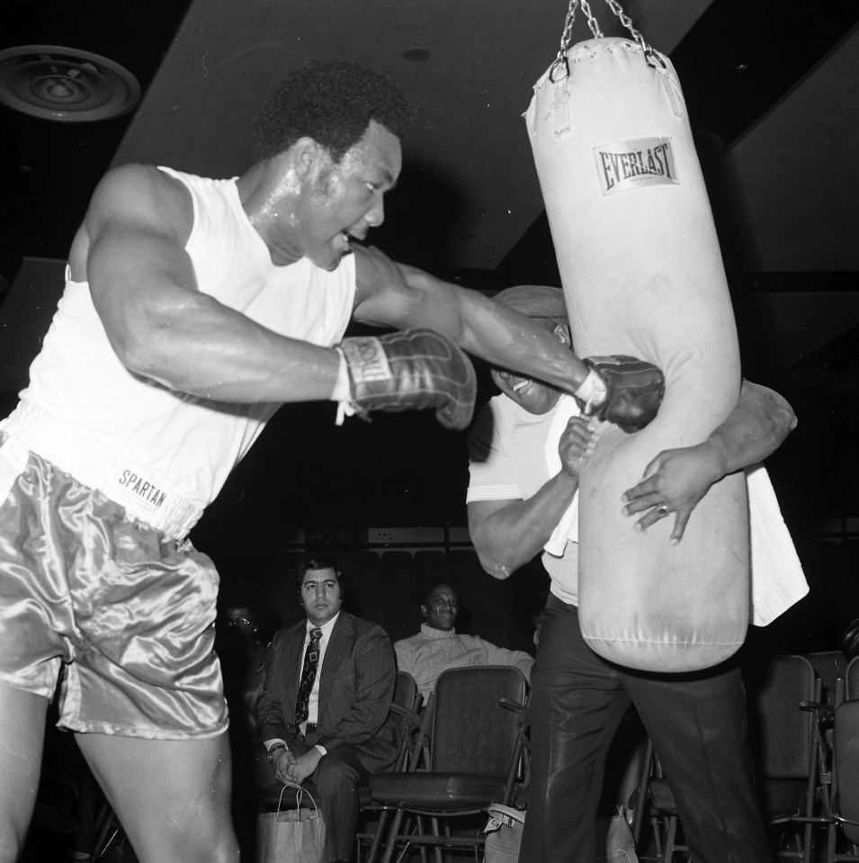 George Foreman training with a punching bag.