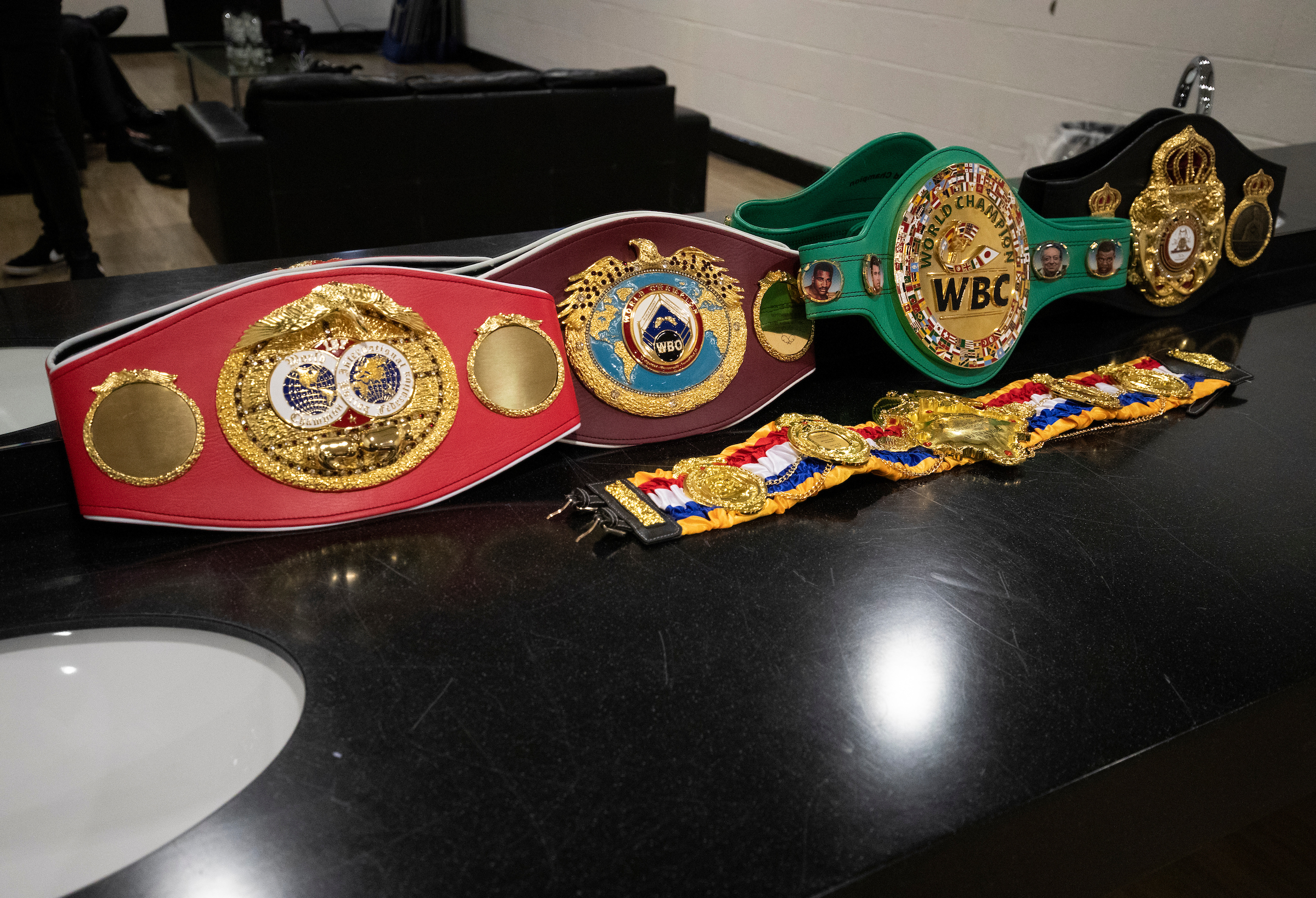 The Ring belts sits as a trophy alongside the four major boxing world titles