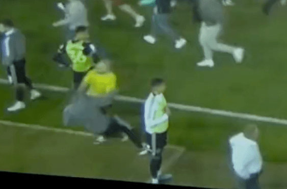 Sharp was shockingly knocked to the ground amid the pitch invasion