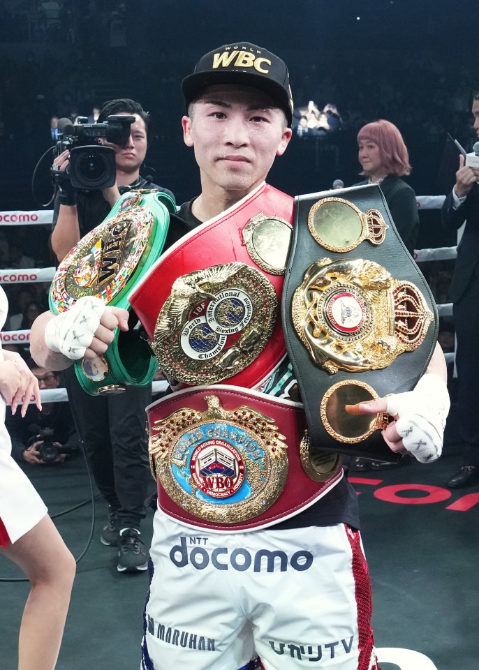 Naoya Inoue, undisputed super-bantamweight world champion, holding his championship belts.
