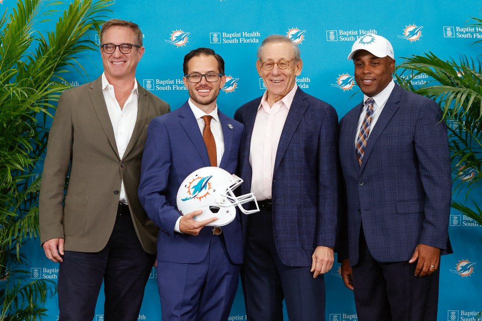 HC Mike McDaniel, second from left, and GM Chris Grier, right, made the Hill trade happen