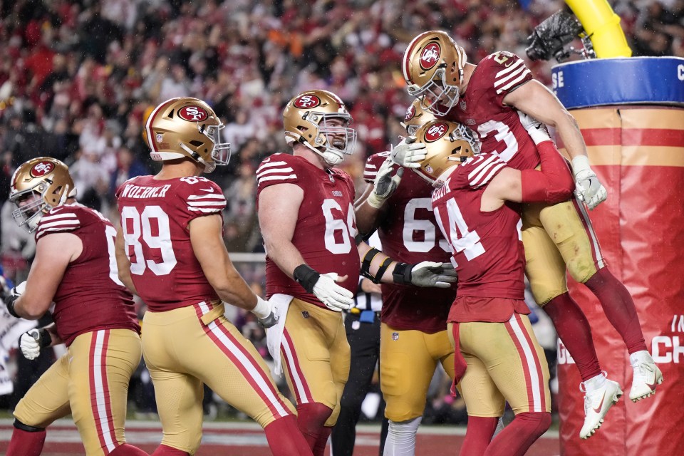 San Francisco lifted Christian McCaffrey into the air after the 49ers scored another TD