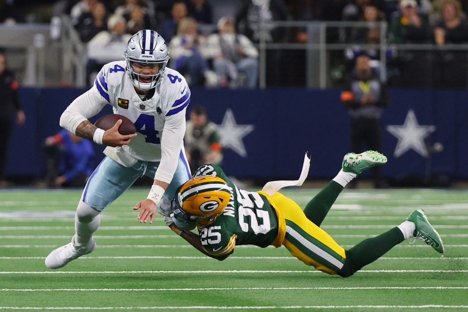 ARLINGTON, TEXAS - JANUARY 14: Dak Prescott #4 of the Dallas Cowboys is sacked by Keisean Nixon #25 of the Green Bay Packers during the first half of the NFC Wild Card Playoff game at AT&T Stadium on January 14, 2024 in Arlington, Texas. (Photo by Richard Rodriguez/Getty Images)