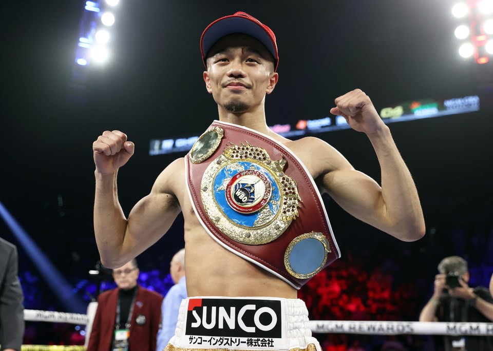 Nakatani, WBC bantamweight world champion, holding his championship belt.