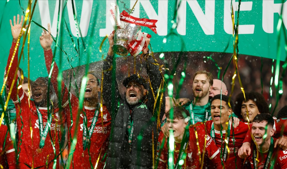 LONDON, ENGLAND - FEBRUARY 25: Jurgen Klopp, Manager of Liverpool celebrates with the trophy and Liverpool players Virgil van Dijk, Ibrahima Konate, Caoimhin Kelleher and Andrew Robertson after winning the Carabao Cup Final match between Chelsea and Liverpool at Wembley Stadium on February 25, 2024 in London, England. (Photo by Nigel French/Sportsphoto/Allstar via Getty Images)