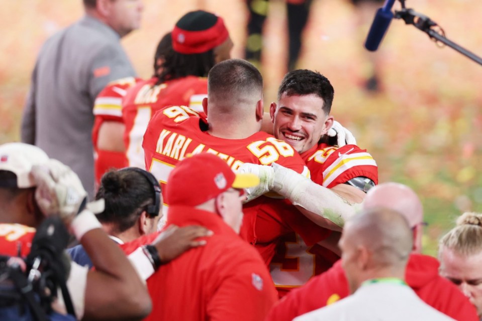 LAS VEGAS, NEVADA - FEBRUARY 11: George Karlaftis #56 and Drue Tranquill #23 of the Kansas City Chiefs celebrates after defeating the San Francisco 49ers 25-22 in overtime during Super Bowl LVIII at Allegiant Stadium on February 11, 2024 in Las Vegas, Nevada. (Photo by Steph Chambers/Getty Images)