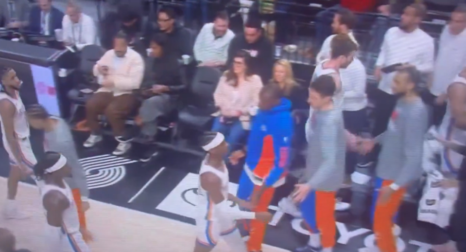 Biyombo (seen in the blue hoodie) high-fived teammates as they walked to the bench