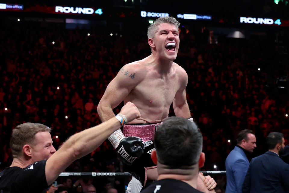 Liam Smith celebrates his victory over Chris Eubank Jr. in a boxing match.