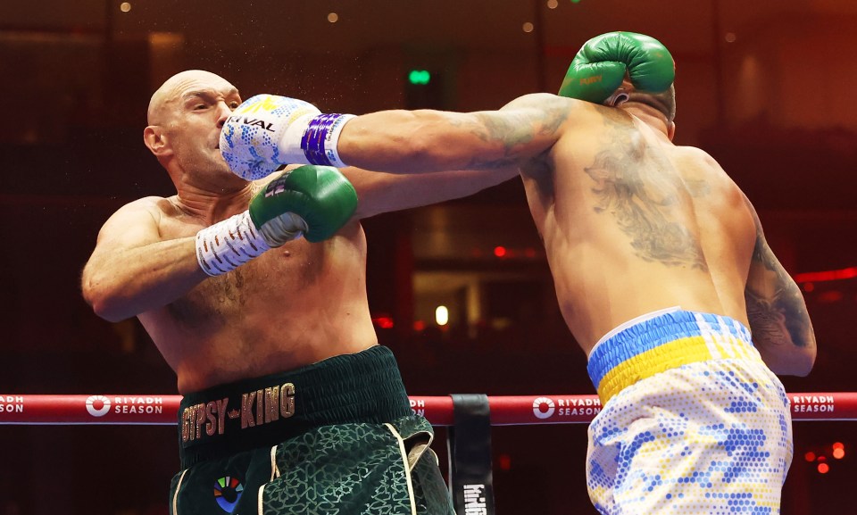 RIYADH, SAUDI ARABIA - MAY 18: Tyson Fury and Oleksandr Usyk exchange punches during the IBF, WBA, WBC, WBO and Undisputed Heavyweight titles' fight between Tyson Fury and Oleksandr Usyk at Kingdom Arena on May 18, 2024 in Riyadh, Saudi Arabia. (Photo by Richard Pelham/Getty Images)