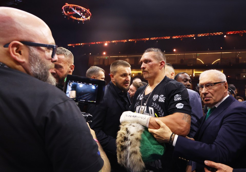 RIYADH, SAUDI ARABIA - MAY 18: Oleksandr Usyk is escorted away from the ring following victory over Tyson Fury (not pictured) in the IBF, WBA, WBC, WBO and Undisputed Heavyweight titles' fight between Tyson Fury and Oleksandr Usyk at Kingdom Arena on May 18, 2024 in Riyadh, Saudi Arabia. (Photo by Richard Pelham/Getty Images)