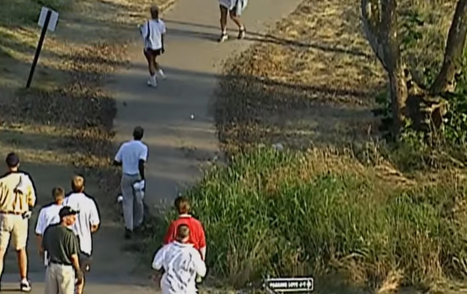 Woods' tee shot went way off target and rolled through a rough area