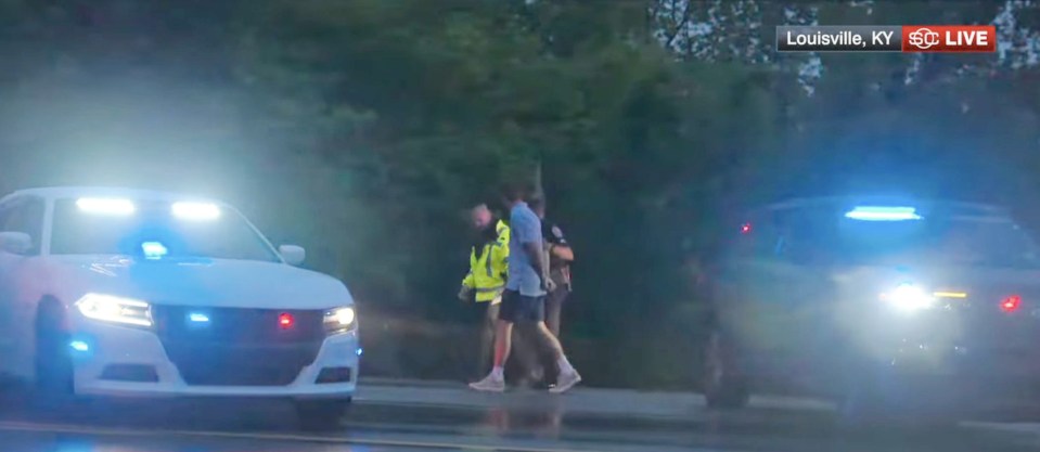 He was walked to a police car by an officer