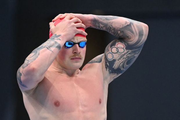 Britain's Adam Peaty prepares to compete in a heat for the men's 100m breaststroke swimming event during the Tokyo 2020 Olympic Games at the Tokyo Aquatics Centre in Tokyo on July 24, 2021. (Photo by Attila KISBENEDEK / AFP) (Photo by ATTILA KISBENEDEK/AFP via Getty Images)