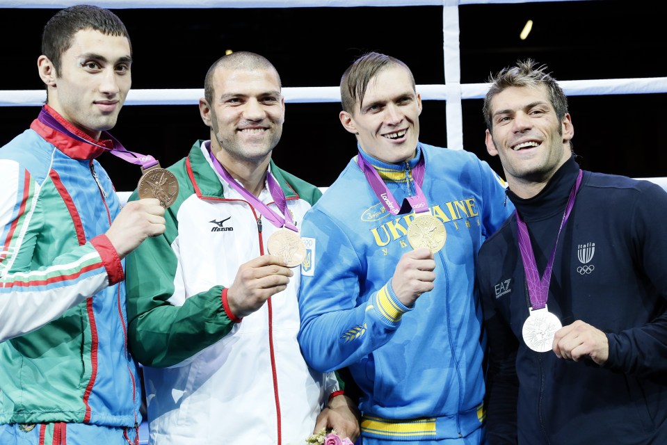Gold medalist Oleksandr Usyk of the Ukraine (2nd-R) stands with silver medalist Clemente Russo of Italy (R), bronze medalists Tervel Pulev of Bulgaria (2nd-L) and Teymur Mammadov of Azerbaijan (L) during the awards ceremony for the Heavyweight (91kg) boxing category of the 2012 London Olympic Games at the ExCel Arena August 11, 2012 in London.      AFP PHOTO / Jack GUEZ        (Photo credit should read JACK GUEZ/AFP/GettyImages)