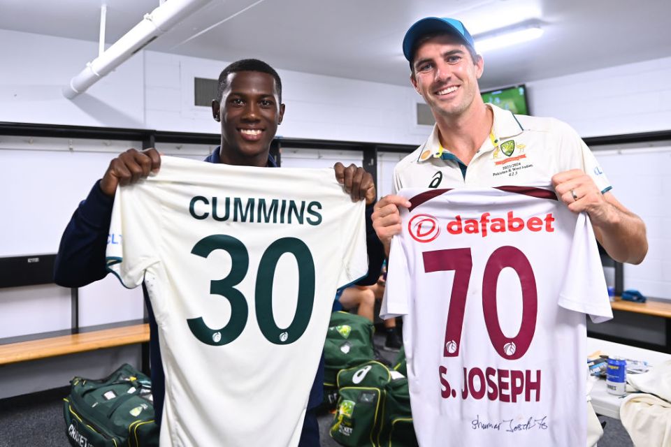 BRISBANE, AUSTRALIA - JANUARY 28: Shamar Joseph of West Indies and Pat Cummins of Australia exchange shirts during day four of the Second Test match in the series between Australia and West Indies at The Gabba on January 28, 2024 in Brisbane, Australia. (Photo by Albert Perez - CA/Cricket Australia via Getty Images)