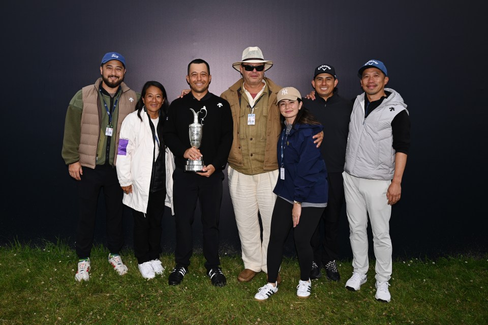 The American's family posed with the Claret Jug on the 18th