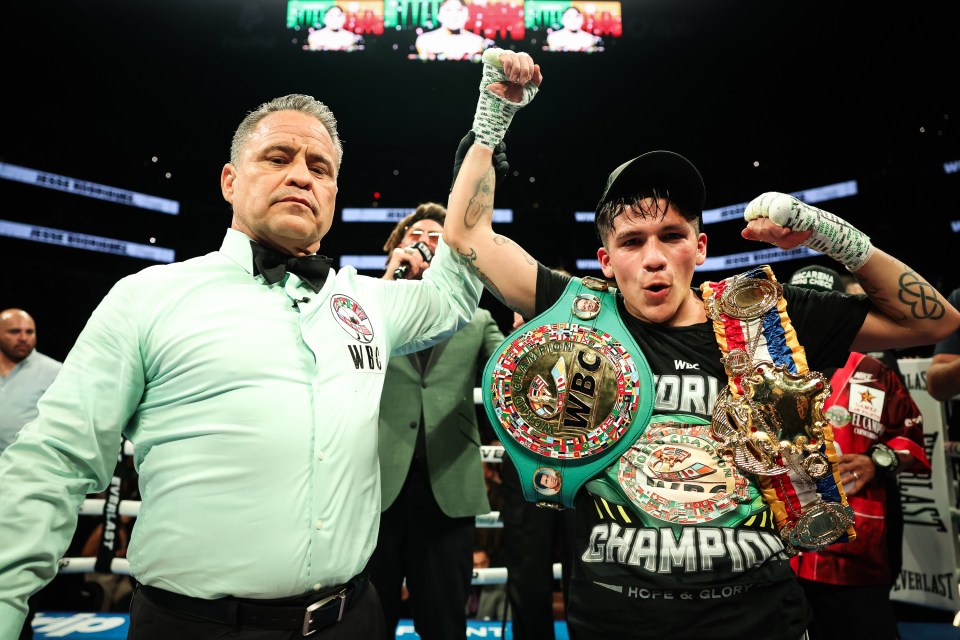 Jesse Bam Rodriguez, WBC super-flyweight world champion, with a referee.