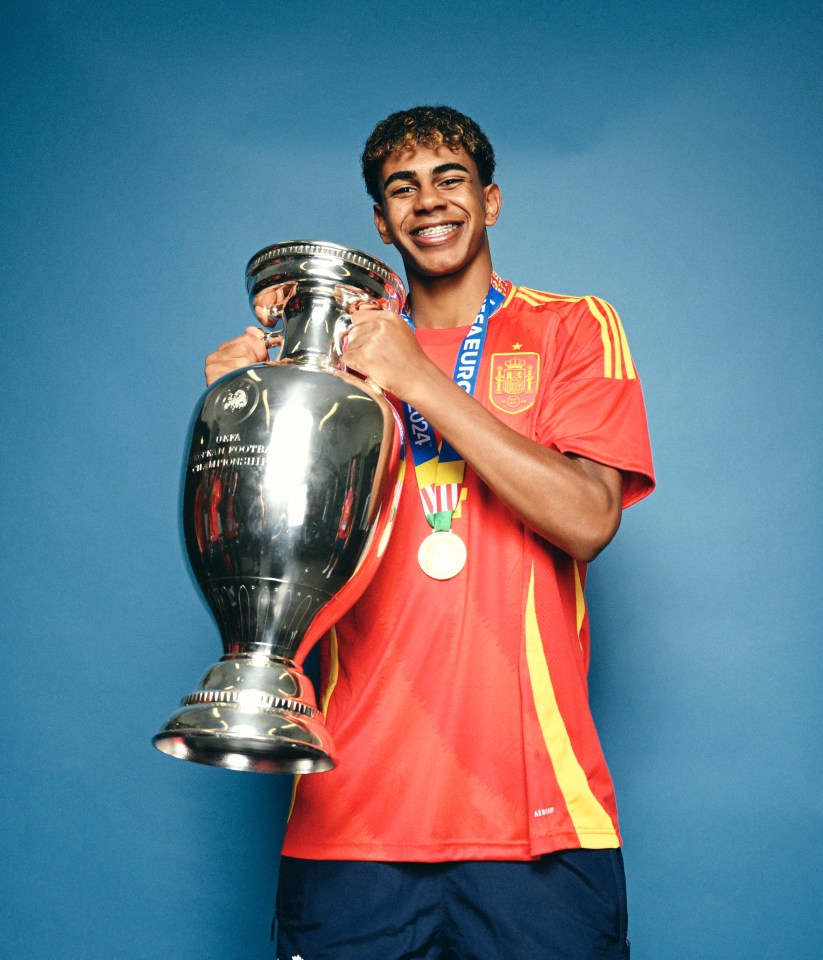 Lamine Yamal holding the UEFA Euro 2024 Henri Delaunay Trophy.