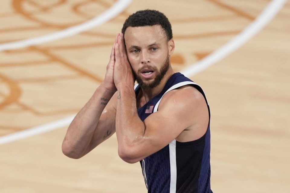 Stephen Curry reacts after making a three-point basket.