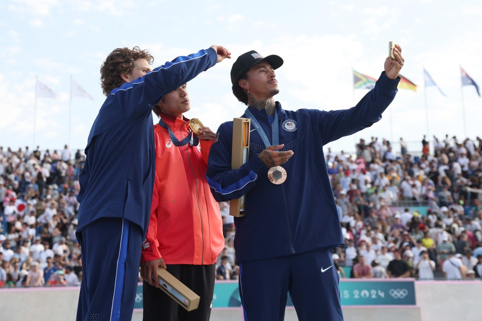 Huston (right) was clearly very proud of his medal - but it's quickly lost its shine