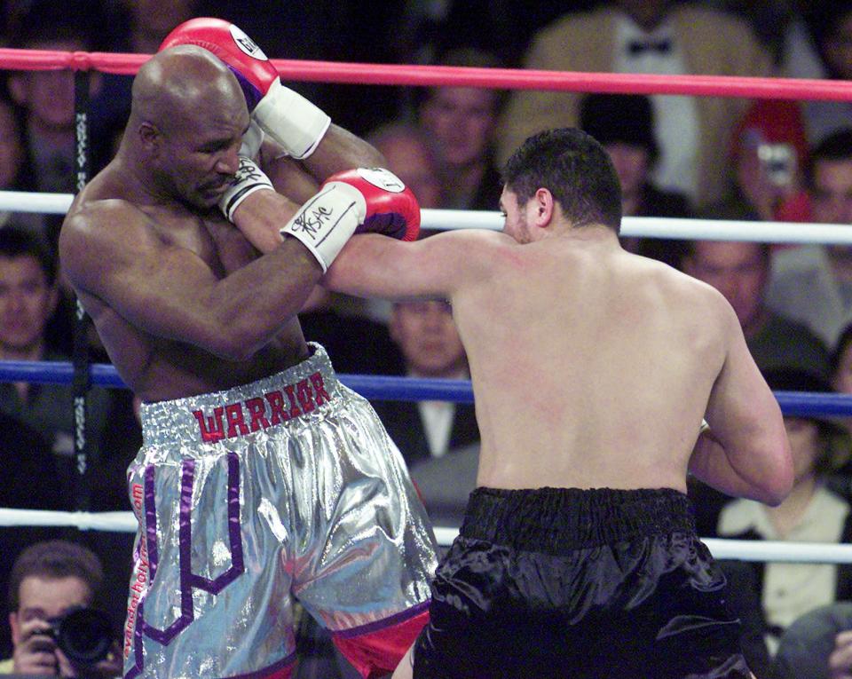 WBA Heavyweight champion Evander Holyfield (L) from the U.S. tries to avoid a left from challenger John Ruiz (R) from Puerto Rico in the 1st round of the title bout at Mandalay Bay in Las Vegas, NV, 03 March, 2001.  AFP PHOTO  Mike NELSON (Photo by MIKE NELSON / AFP) (Photo by MIKE NELSON/AFP via Getty Images)