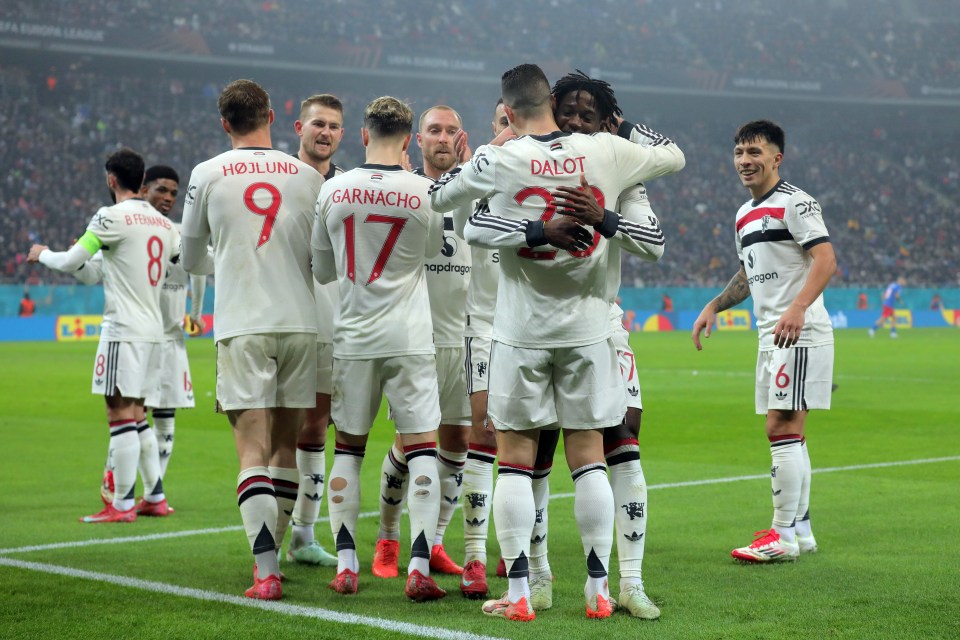 BUCHAREST, ROMANIA - JANUARY 30: Diogo Dalot of Manchester United celebrates scoring his team's first goal with teammate Kobbie Mainoo during the UEFA Europa League 2024/25 League Phase MD8 match between Fotbal Club FCSB and Manchester United at National Arena on January 30, 2025 in Bucharest, Romania. (Photo by Vasile Mihai-Antonio/Getty Images)