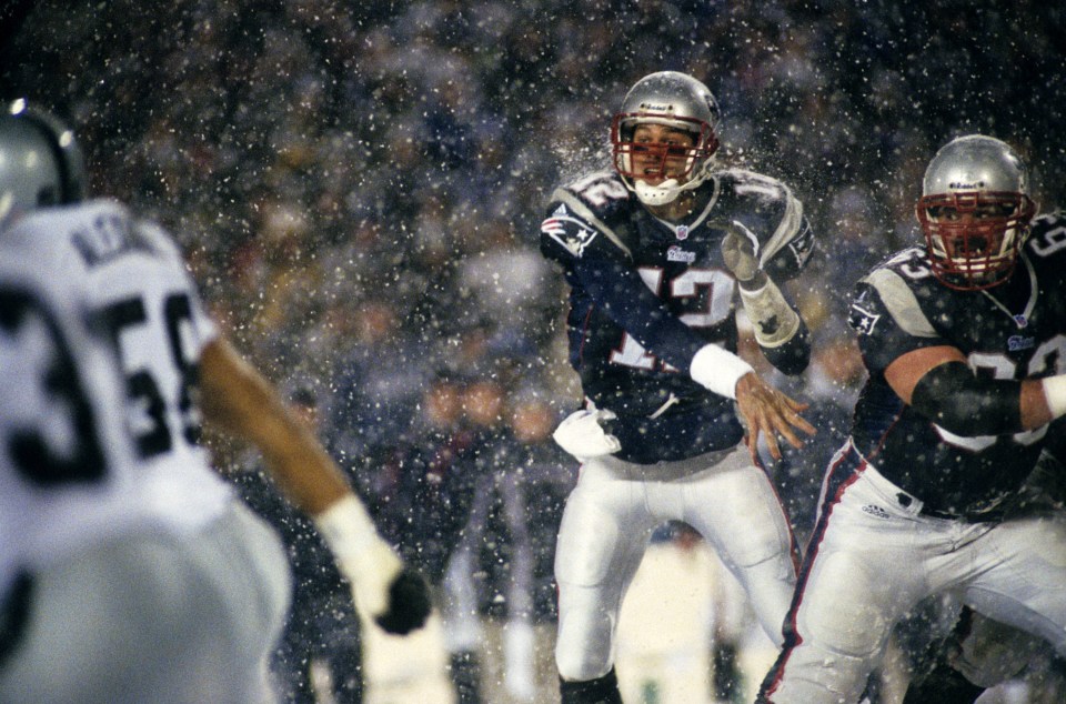 New England Patriots quarterback Tom Brady (12) throws a pass during the Patriots 16-13 overtime victory over the Oakland Raiders in the 2001 AFC Divisional Playoff Game on January 19, 2002 at Foxboro Stadium in Foxboro, Massachusetts.  This game, known as the "Snow Bowl," was the final game ever played at Foxboro Stadium. (Photo by Arthur Anderson/Getty Images)