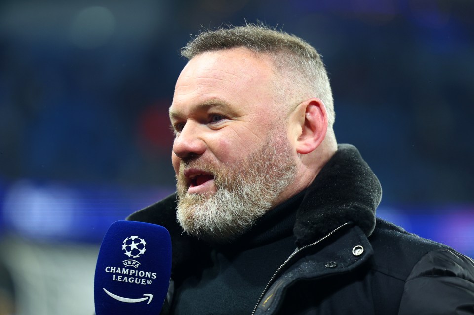 Wayne Rooney speaking into a Champions League microphone.
