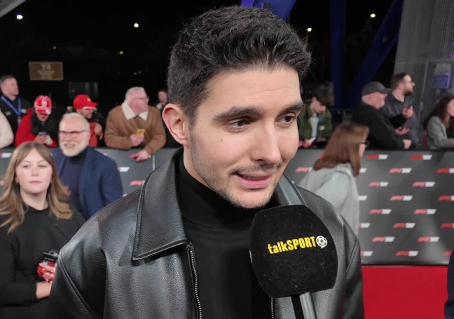 Esteban Ocon being interviewed on a red carpet.
