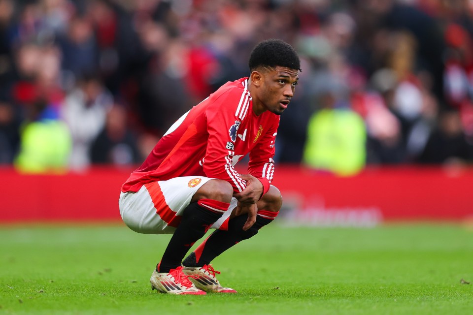 Amad Diallo of Manchester United crouching on the field after a match.