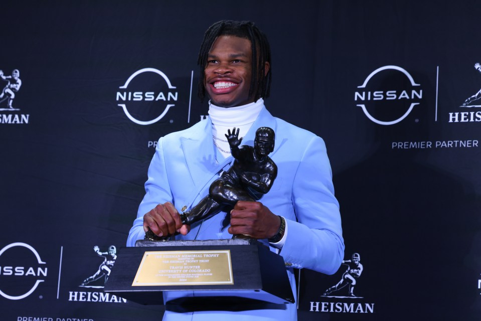 NEW YORK, NY - DECEMBER 14:  Travis Hunter University of Colorado cornerback/wide receiver poses with the Trophy during the Heisman Trophy press conference at the Marriott Marquis on December 14, 2024 in New York, New York. (Photo by Rich Graessle/Icon Sportswire via Getty Images)