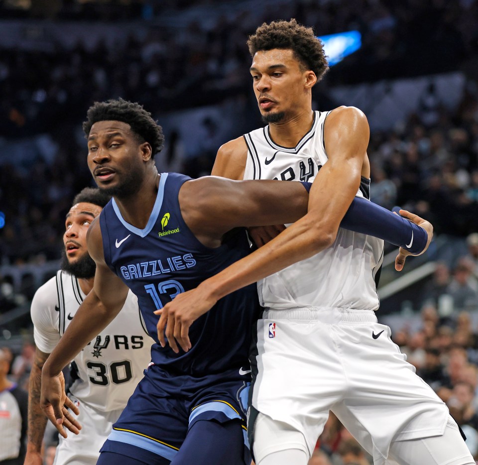 SAN ANTONIO, TX - JANUARY 17:  Victor Wembanyama  fights for rebounding position with Jaren Jackson #13 of the Memphis Grizzlies for a loose ball in the first half at Frost Bank Center on January 17, 2025 in San Antonio, Texas. NOTE TO USER: User expressly acknowledges and agrees that, by downloading and or using this photograph, User is consenting to terms and conditions of the Getty Images License Agreement. (Photo by Ronald Cortes/Getty Images)