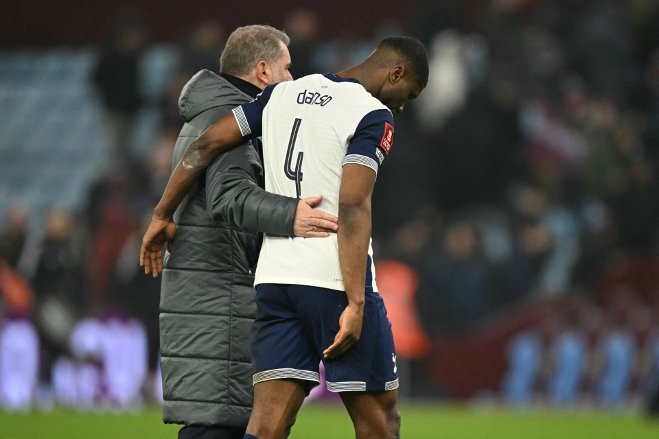 Tottenham Hotspur's Greek-Australian Head Coach Ange Postecoglou consoles Tottenham Hotspur's Austrian defender #04 Kevin Danso (R) after the English FA Cup fourth round football match between Aston Villa and Tottenham Hotspur at Villa Park in Birmingham, central England on February 9, 2025. Villa won the game 2-1. (Photo by JUSTIN TALLIS / AFP) / RESTRICTED TO EDITORIAL USE. No use with unauthorized audio, video, data, fixture lists, club/league logos or 'live' services. Online in-match use limited to 120 images. An additional 40 images may be used in extra time. No video emulation. Social media in-match use limited to 120 images. An additional 40 images may be used in extra time. No use in betting publications, games or single club/league/player publications. /  (Photo by JUSTIN TALLIS/AFP via Getty Images)