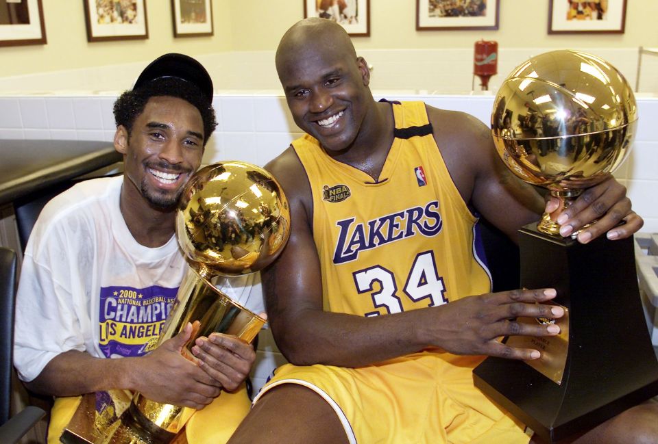 LOS ANGELES, UNITED STATES:  Kobe Bryant (L) of the Los Angeles Lakers holds the Larry O'Brian trophy as teammate Shaquille O'Neal (L) hold the MVP trophy after winning the NBA Championship against Indiana Pacers 19 June, 2000, after game six of the NBA Finals at Staples Center in Los Angeles, CA. The Lakers won the game 116-111 to take the NBA title 4-2 in the best-of-seven series. (ELECTRONIC IMAGE)  AFP PHOTO (Photo credit should read AFP/AFP via Getty Images)