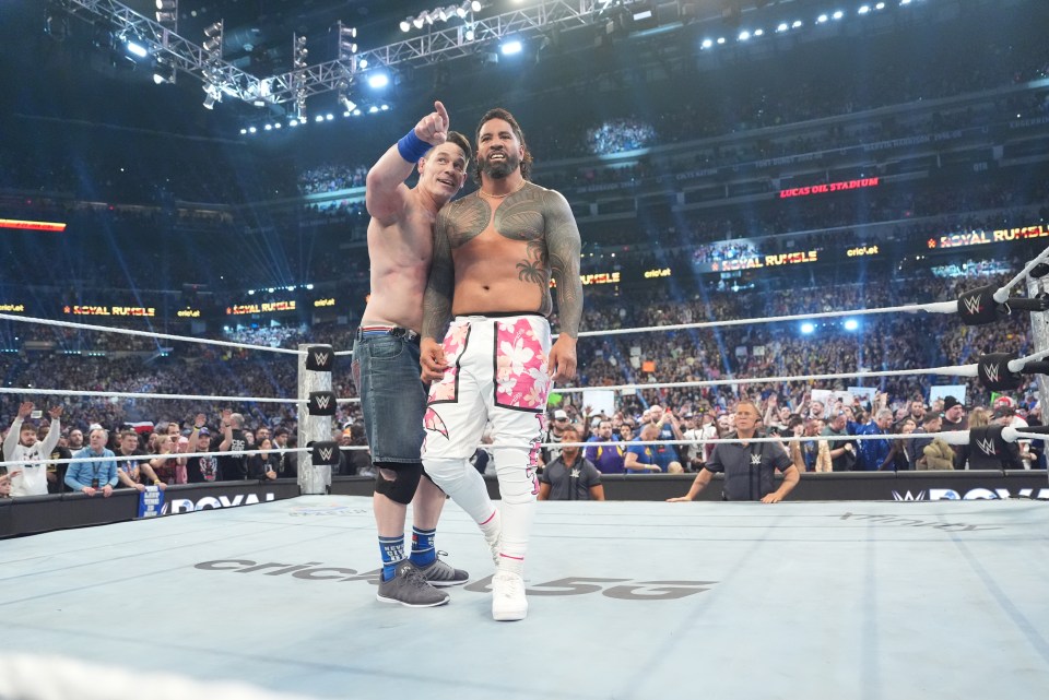 Cena and Uso in a wrestling ring.