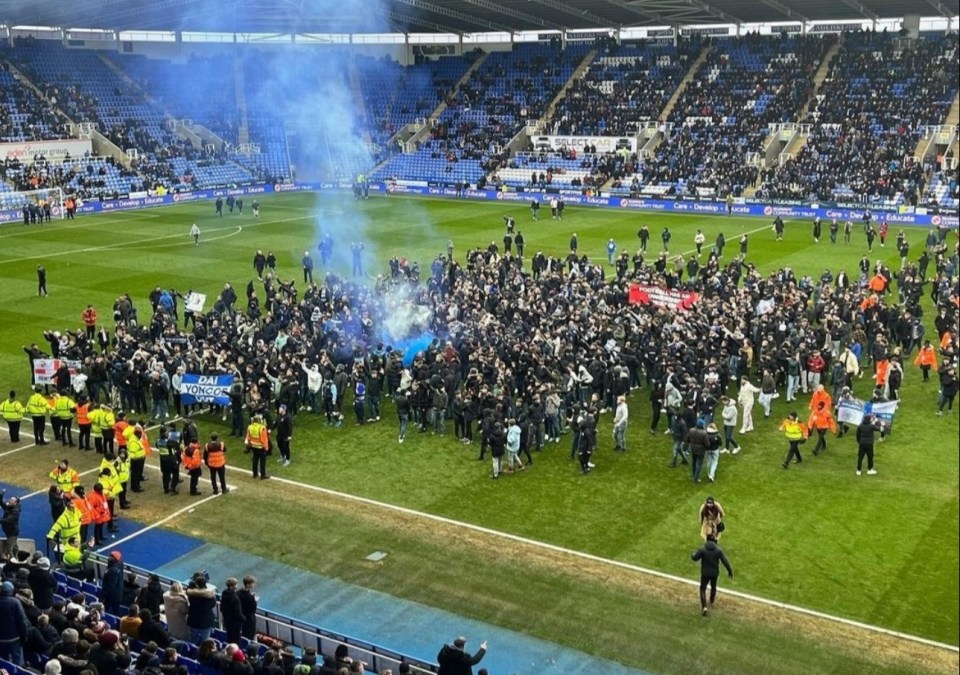 Reading fans protesting on the pitch.