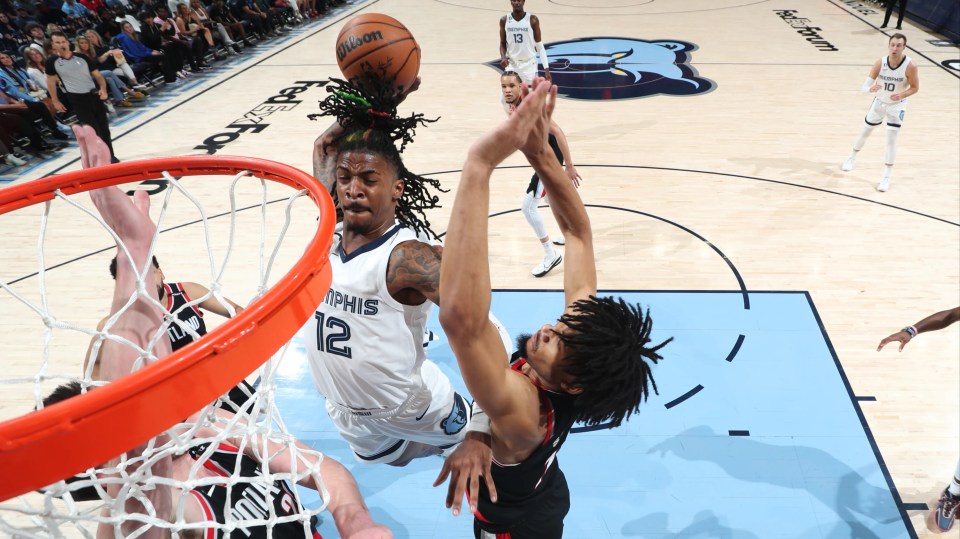 Ja Morant dunking a basketball.