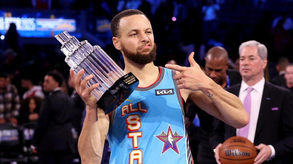 Stephen Curry holding the NBA All-Star Game MVP trophy.
